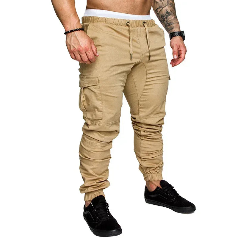 Beige cargo jogger pants worn by a person on a white background