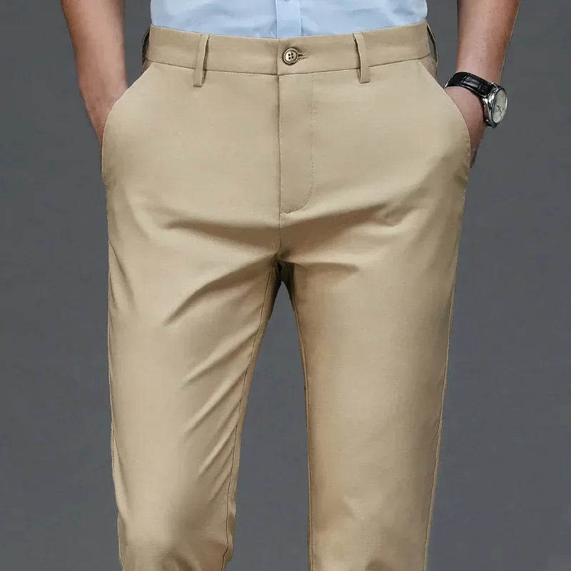 Beige pants worn by a person on a gray background