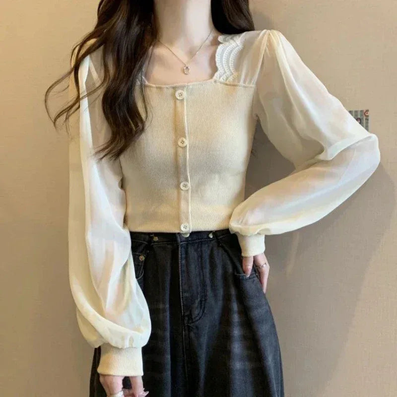 Person wearing a sheer beige blouse with long sleeves against a neutral background