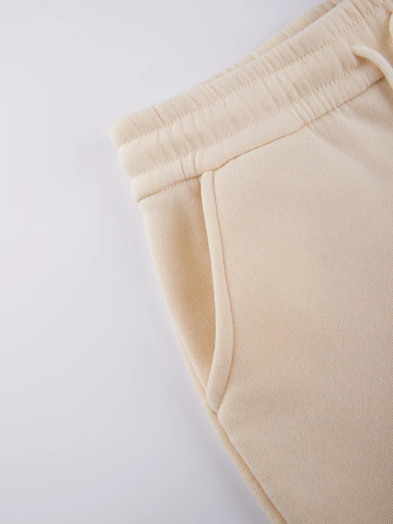 Beige sweatpants on a light gray background