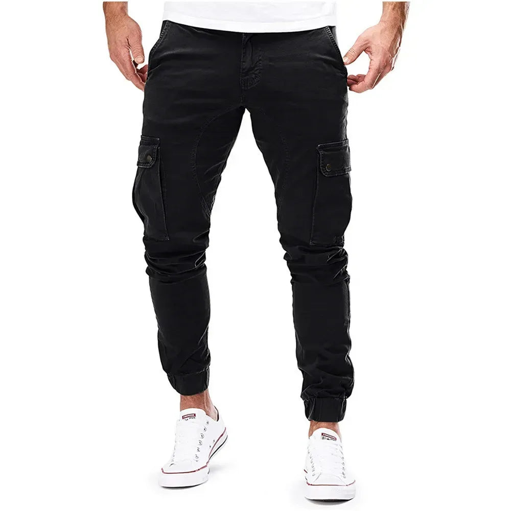 Black cargo pants worn by a person on a white background