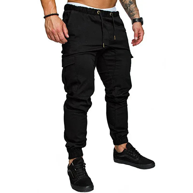 Black cargo pants worn by a person on a white background