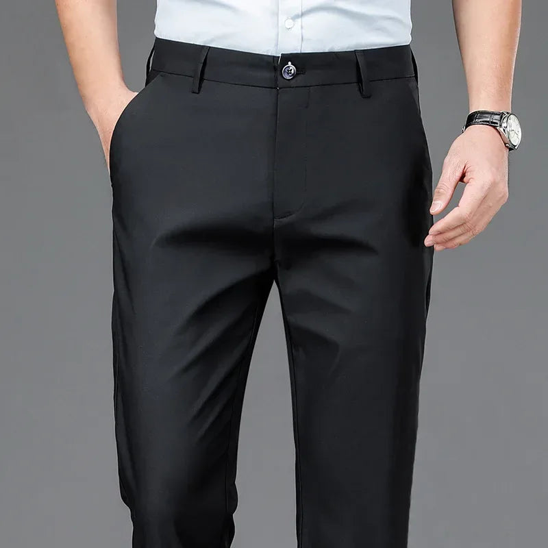Person wearing black dress pants on a gray background