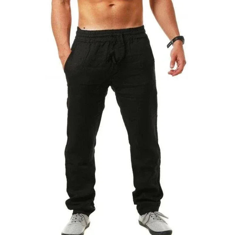 Black pants worn by a person on a white background