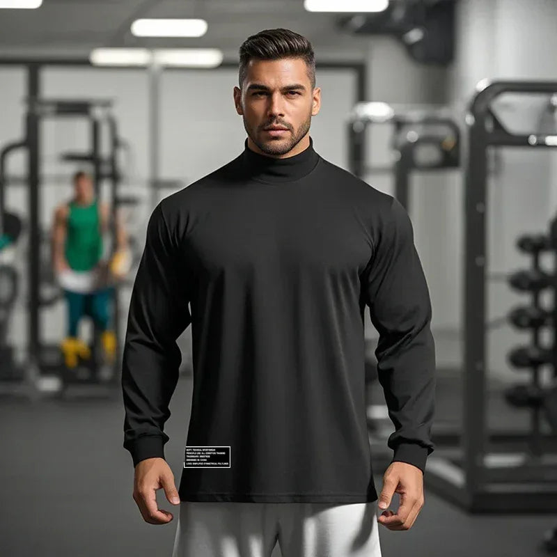 Man wearing a black long-sleeve shirt in a gym setting