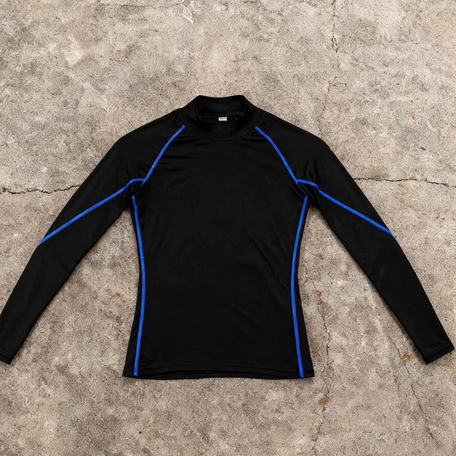 Black long-sleeve shirt with blue accents on a concrete surface