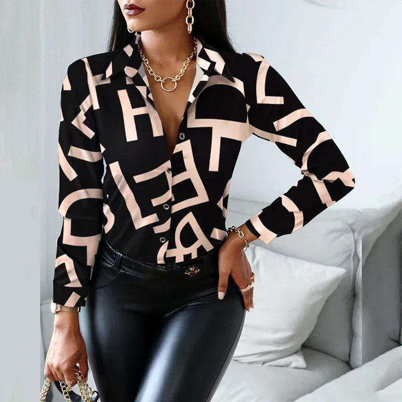 Woman wearing a black and beige patterned blouse with leather pants in a room.