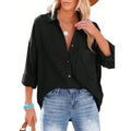Woman wearing a black button-up shirt and blue jeans on a white background