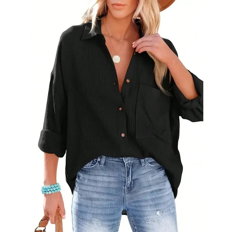 Woman wearing a black button-up shirt and blue jeans on a white background
