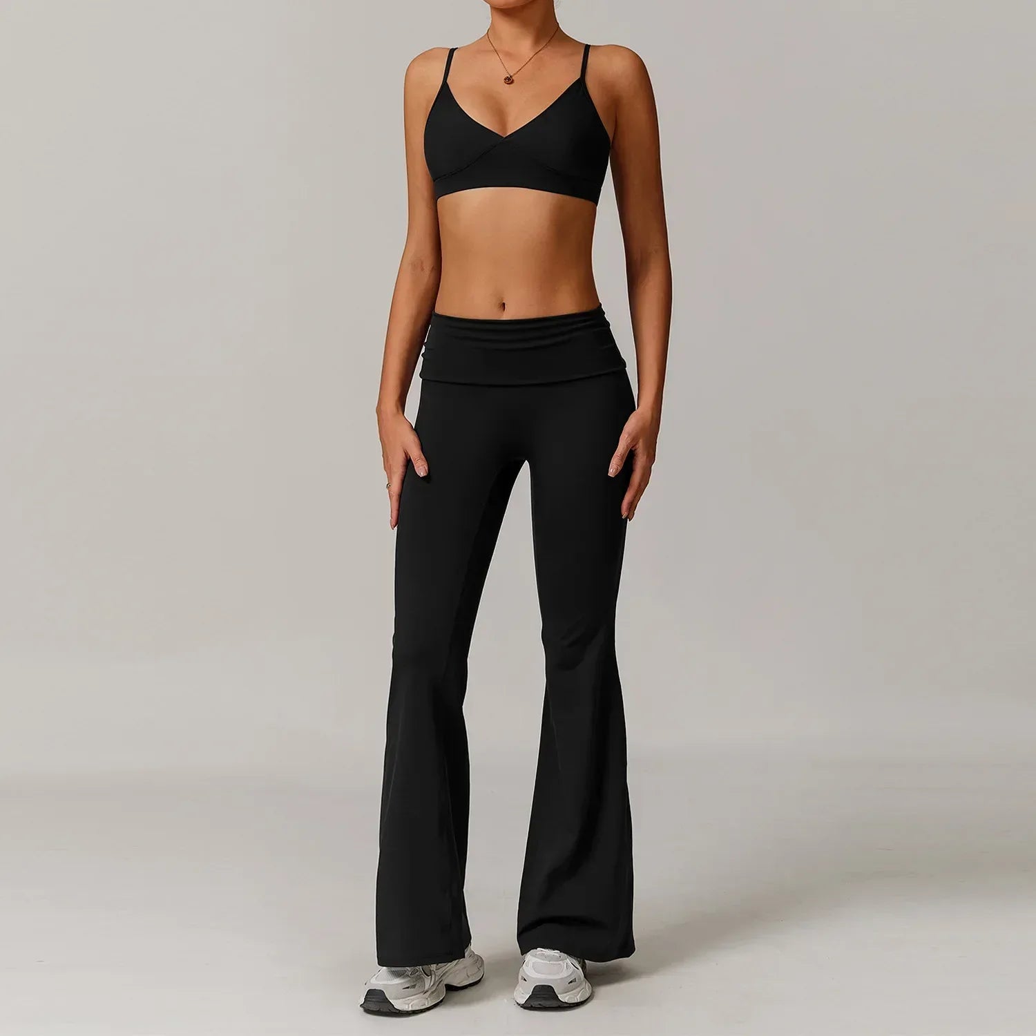 Woman wearing a black push up sports bra and high waisted wide leg yoga pants with tummy control for a slimming gym or lounge outfit - BetterPlace