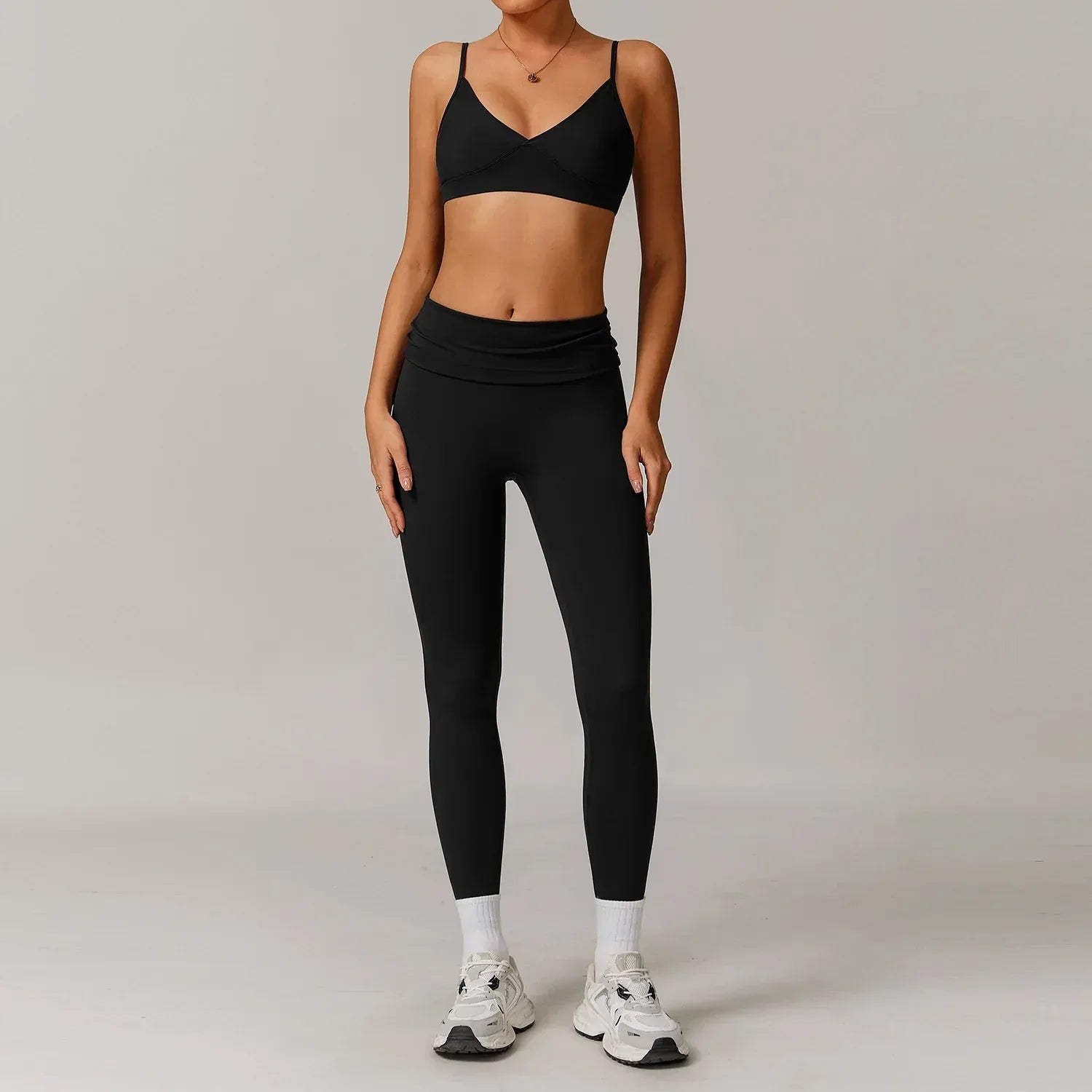 Woman wearing a black push up sports bra and high waisted scrunch butt leggings for a seamless booty lifting workout outfit - BetterPlace