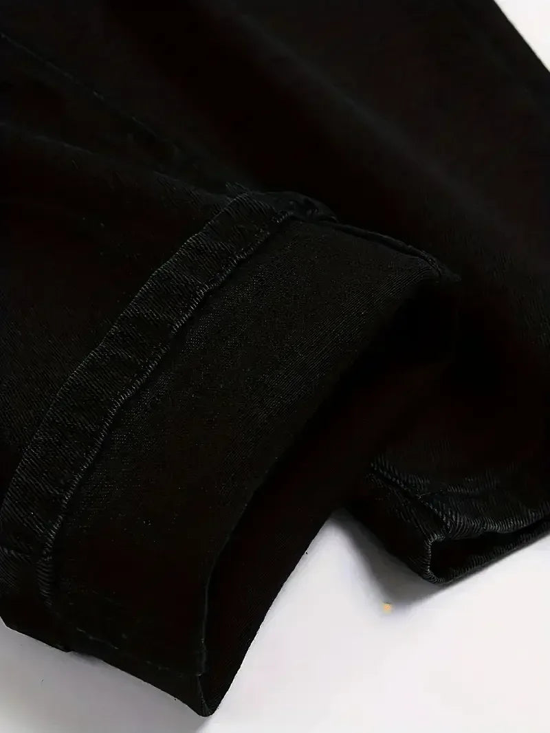 Close-up of a black denim jeans on a white background