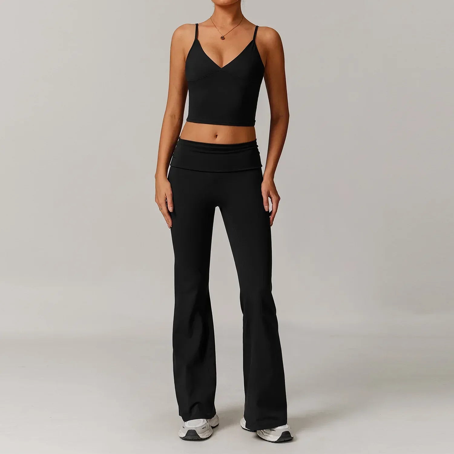 Matching two-piece black activewear set featuring a v-neck tank top and high-waisted wide leg yoga pants - BetterPlace