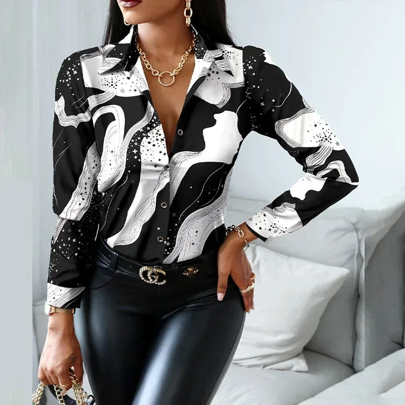 Woman wearing a black and white patterned shirt with leather pants in a living room setting.