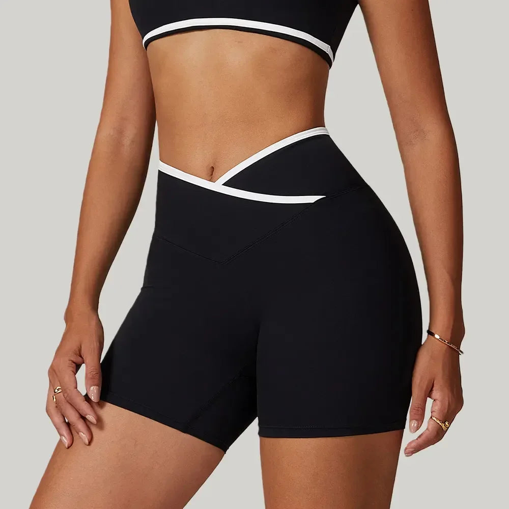 black Side view of women’s crossover high-waisted shorts showing the seamless pocket construction and athletic compression fit - BetterPlace