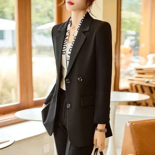 Person wearing a black suit in a cafe setting