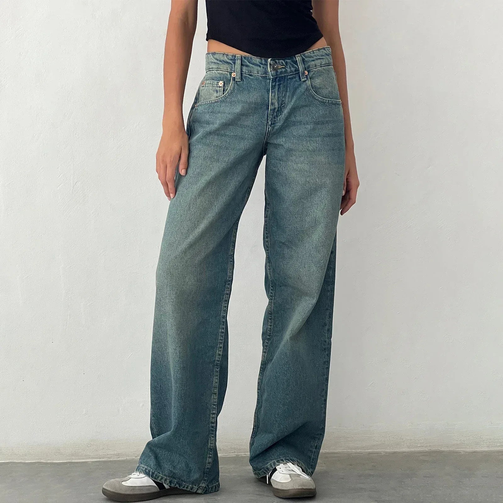 Person wearing wide-leg jeans against a plain background