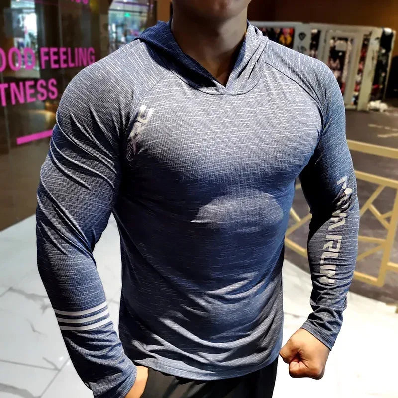 Person wearing a blue and gray long-sleeve athletic shirt in a gym setting