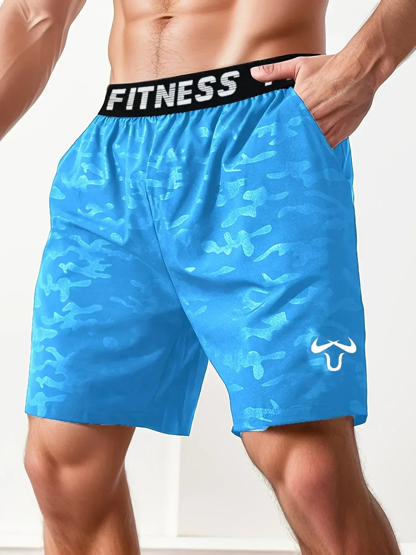 Blue camouflage fitness shorts with a visible brand logo on a white background