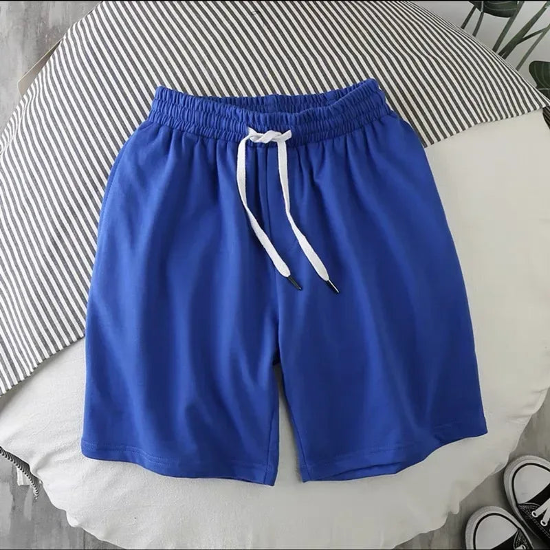 Blue shorts with a white drawstring on a striped fabric background