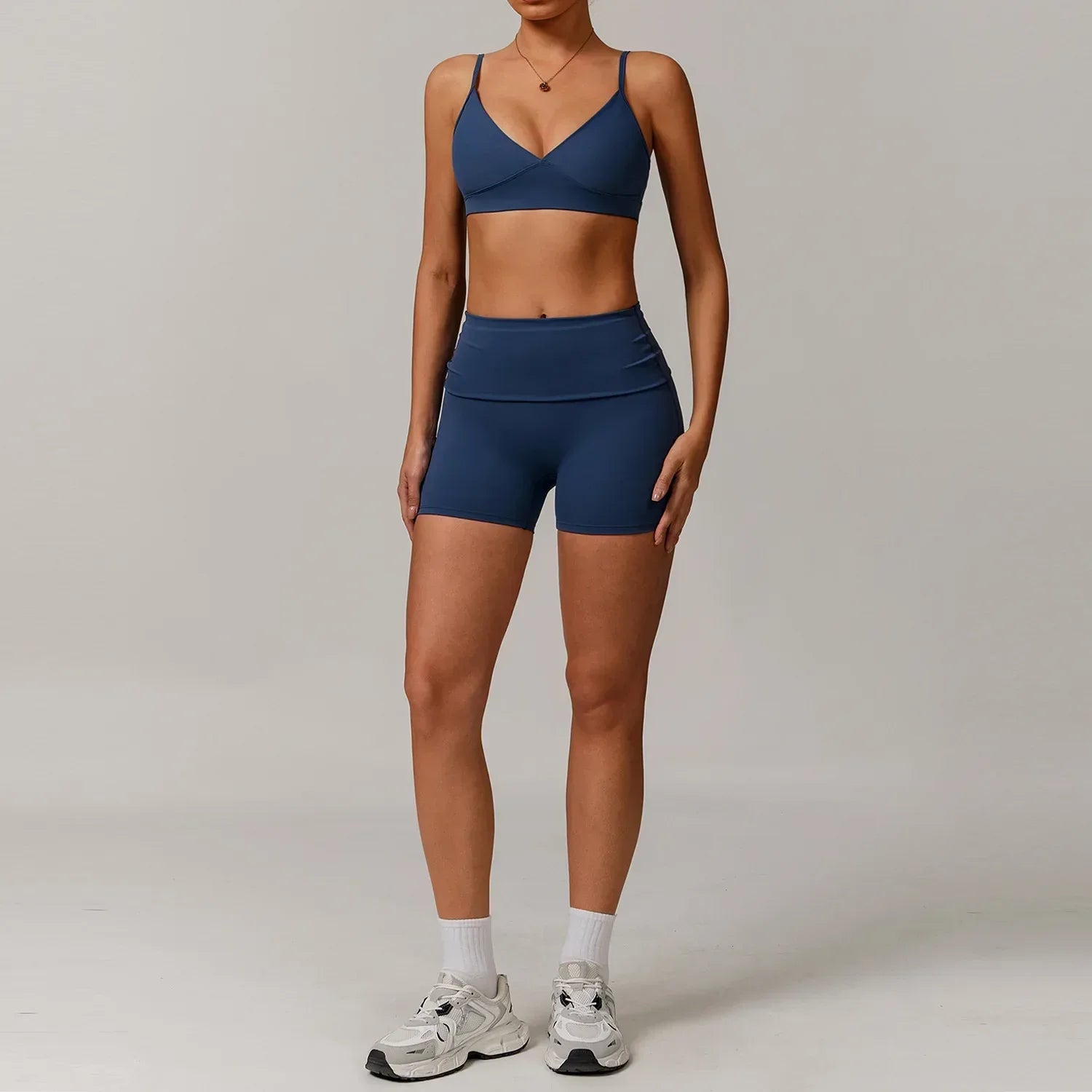 Matching two-piece blue workout set with a supportive push up sports bra and high-waisted compression shorts - BetterPlace