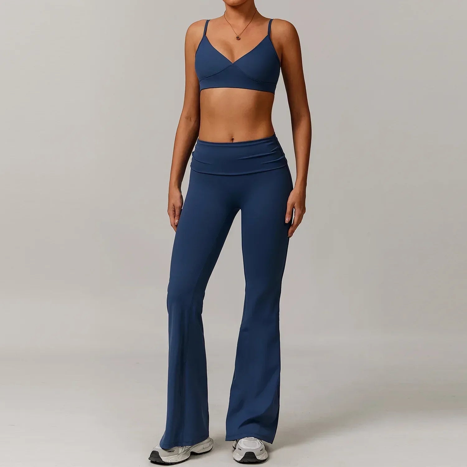 Two-piece blue yoga set featuring a supportive push up sports bra and high-waisted wide leg flared pants - BetterPlace