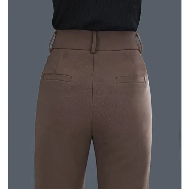 Brown pants worn by a person on a gray background