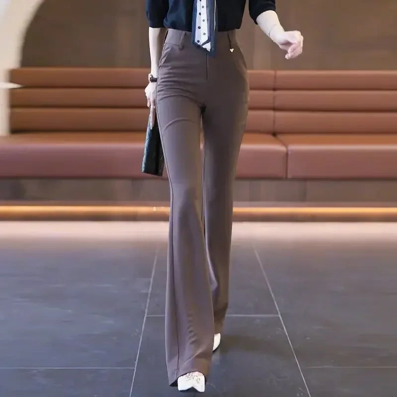 Person wearing brown flared pants in an indoor setting