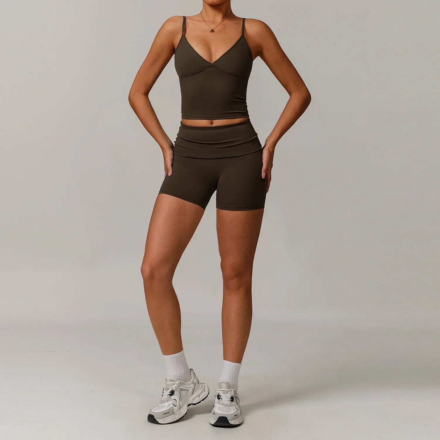 Woman wearing a chocolate brown v-neck tank top and matching high waisted seamless shorts for a coffee-colored gym or yoga set - BetterPlace