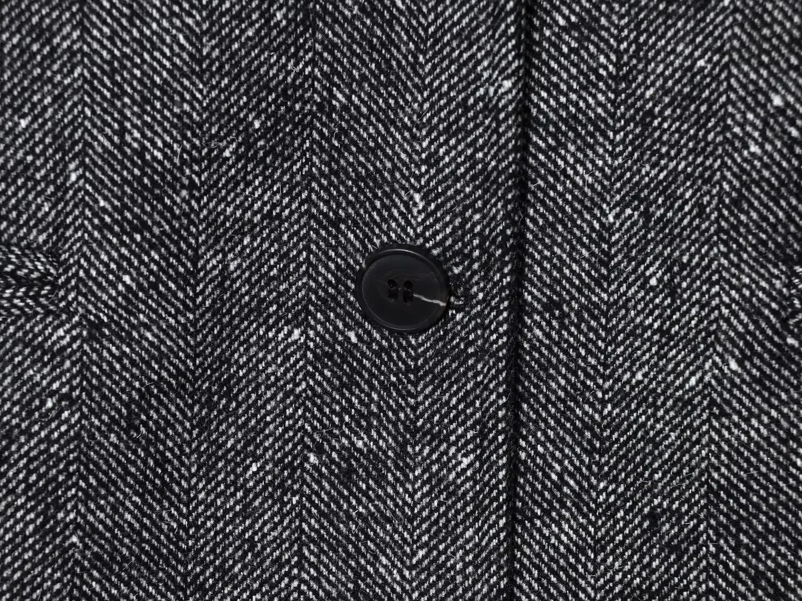 Close-up of a textured fabric with a button in the center