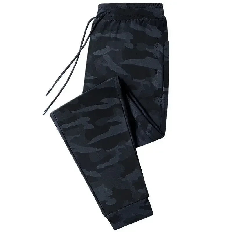 Black camouflage pants on a white background