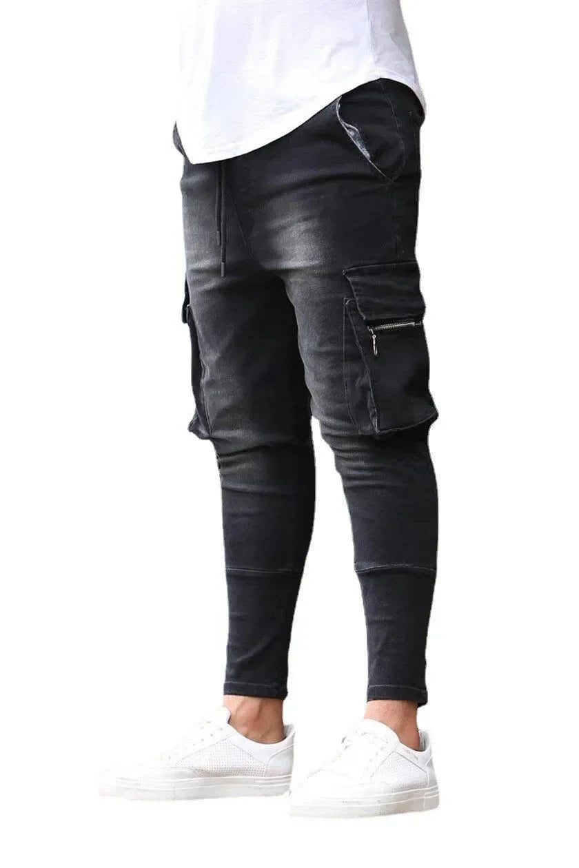 Black leather jogger pants worn by a person on a white background