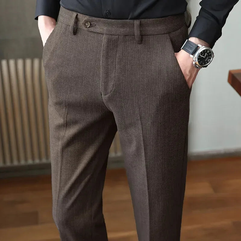 Person wearing brown dress pants with a blurred background