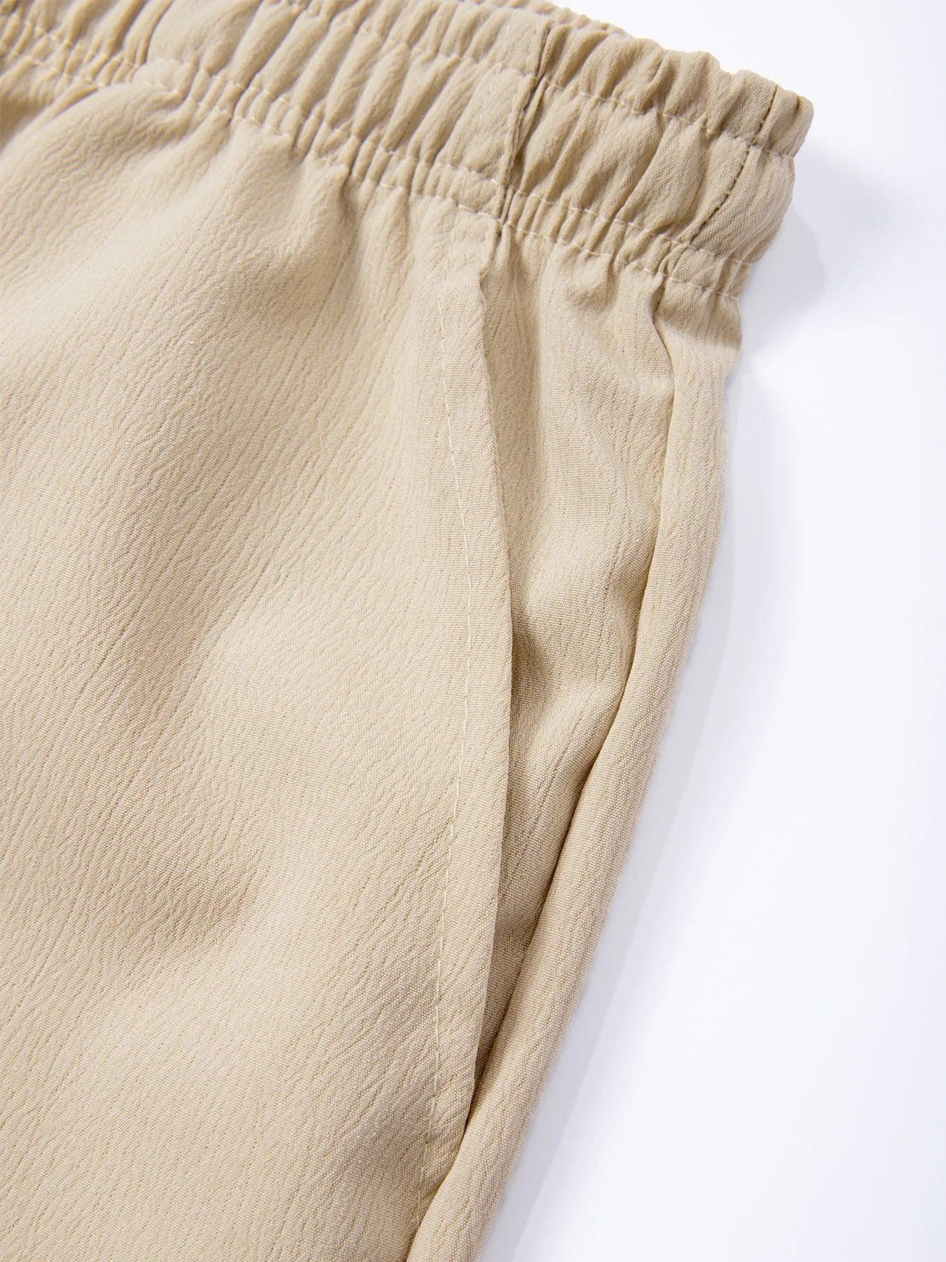 Close-up of beige pants with an elastic waistband on a white background