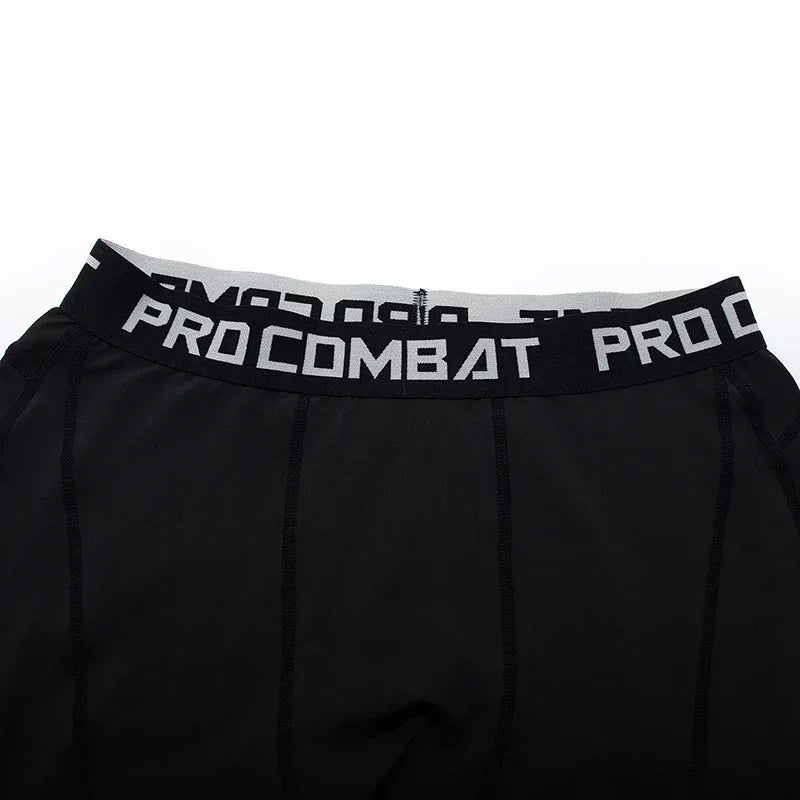Black athletic shorts with 'Pro Combat' waistband on a white background