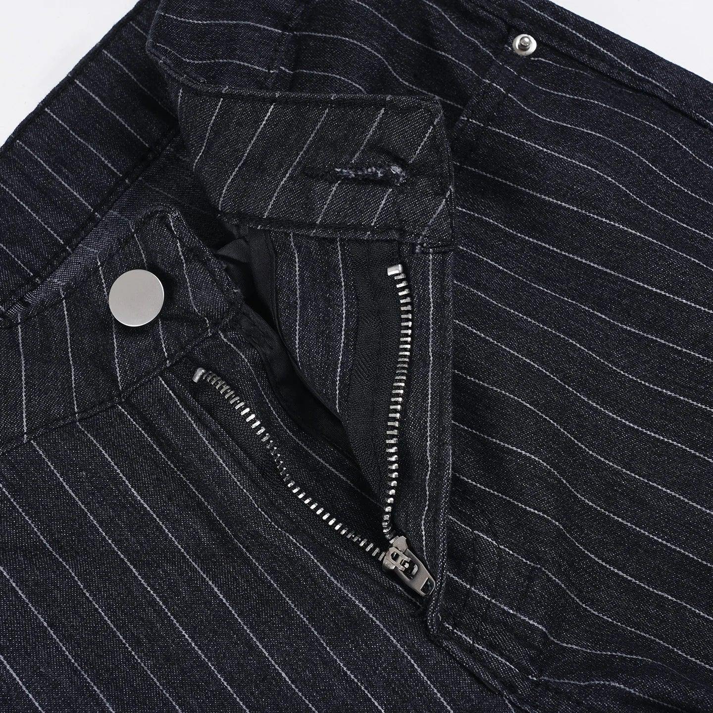 Close-up of a black pinstripe jacket with buttons and zippers on a white background