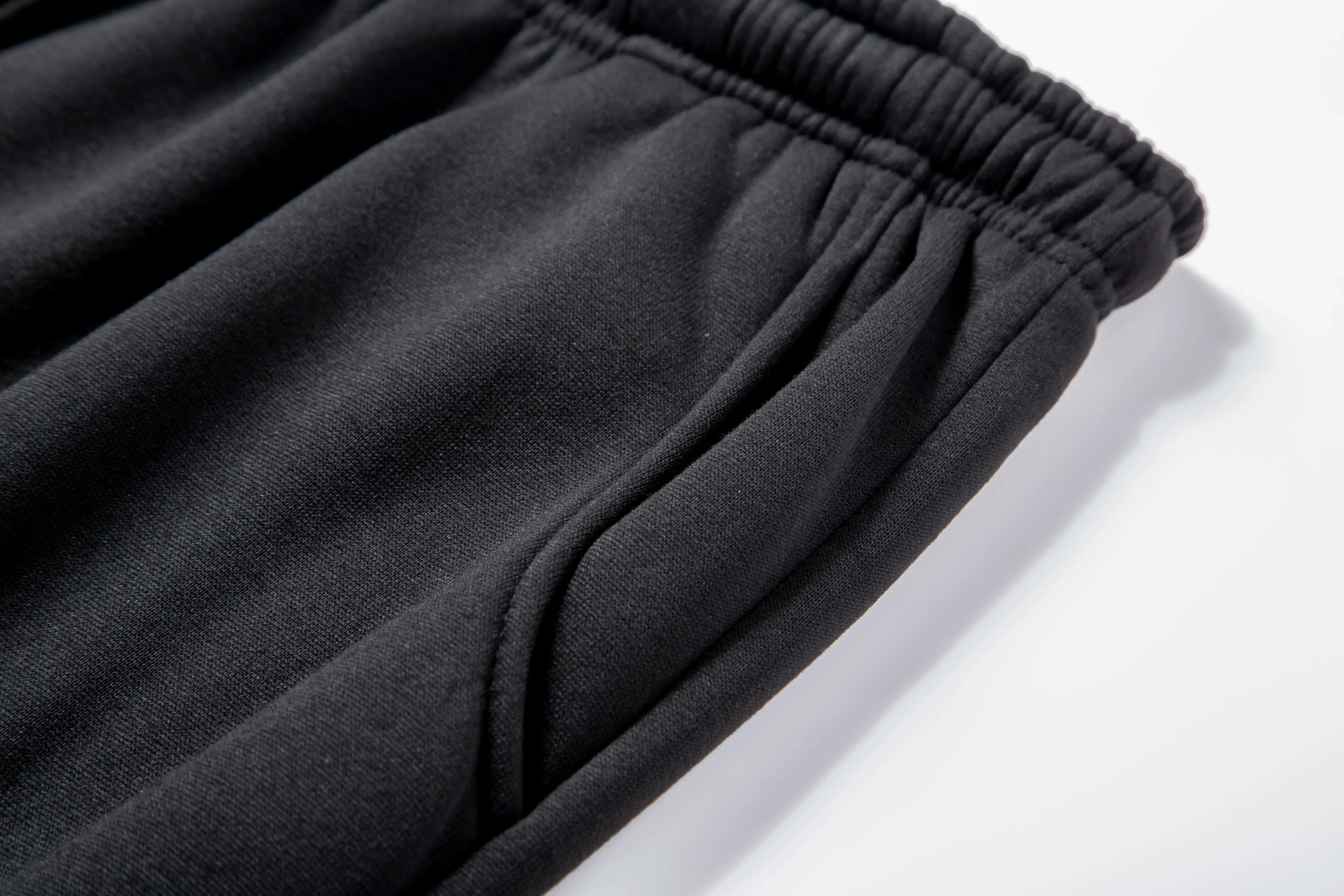 Close-up of black pants on a white background