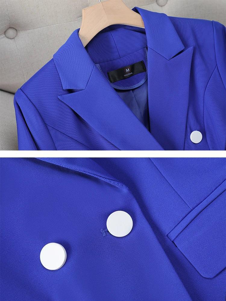 Blue blazer with white buttons on a gray surface
