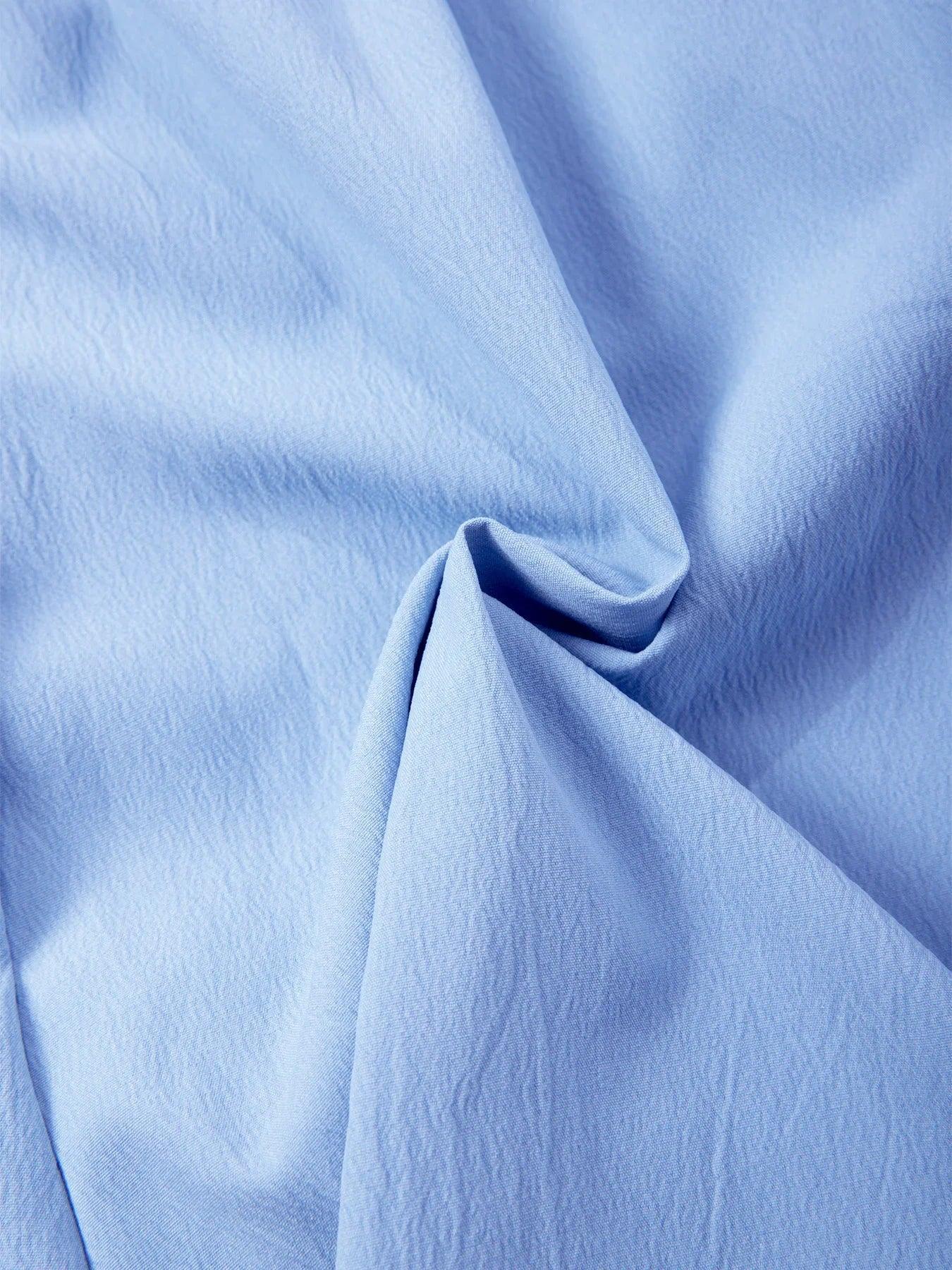Close-up of light blue fabric with folds