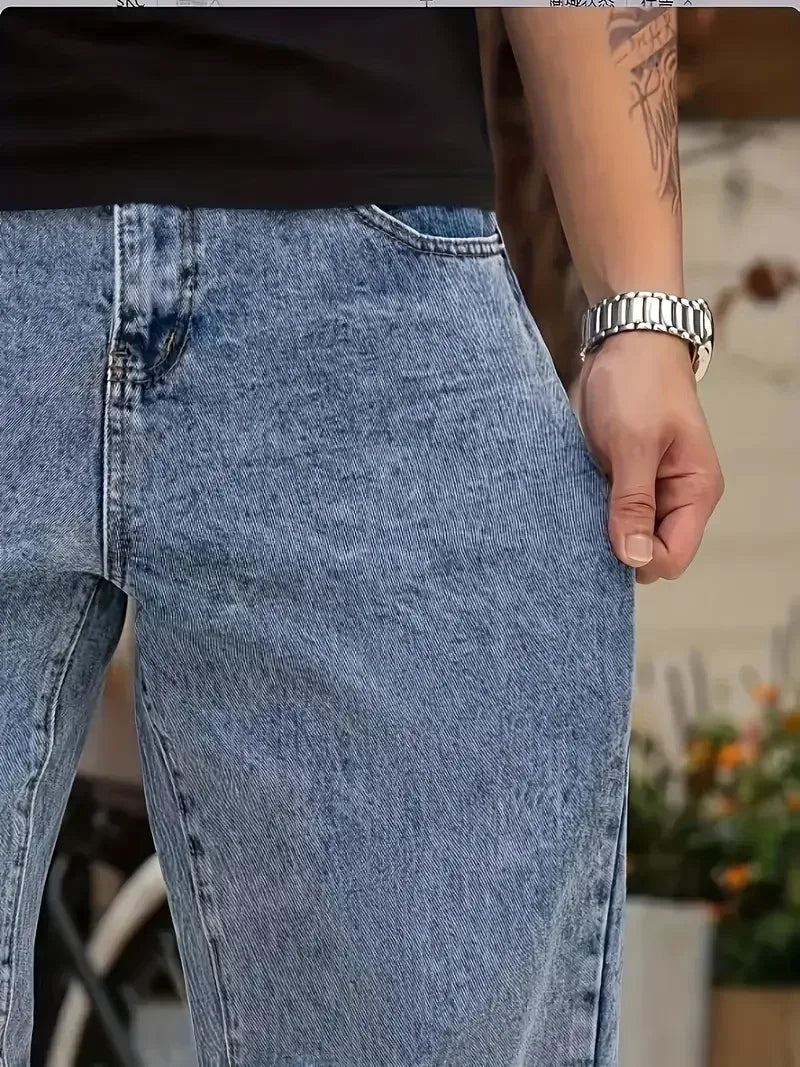 Person wearing blue jeans with a blurred background