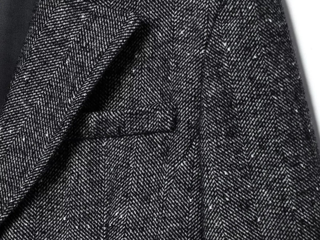 Close-up of dark gray herringbone fabric texture