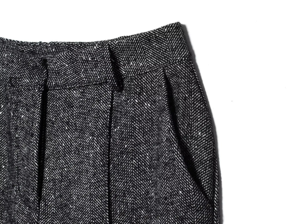 Close-up of a textured gray fabric with pleats on a white background