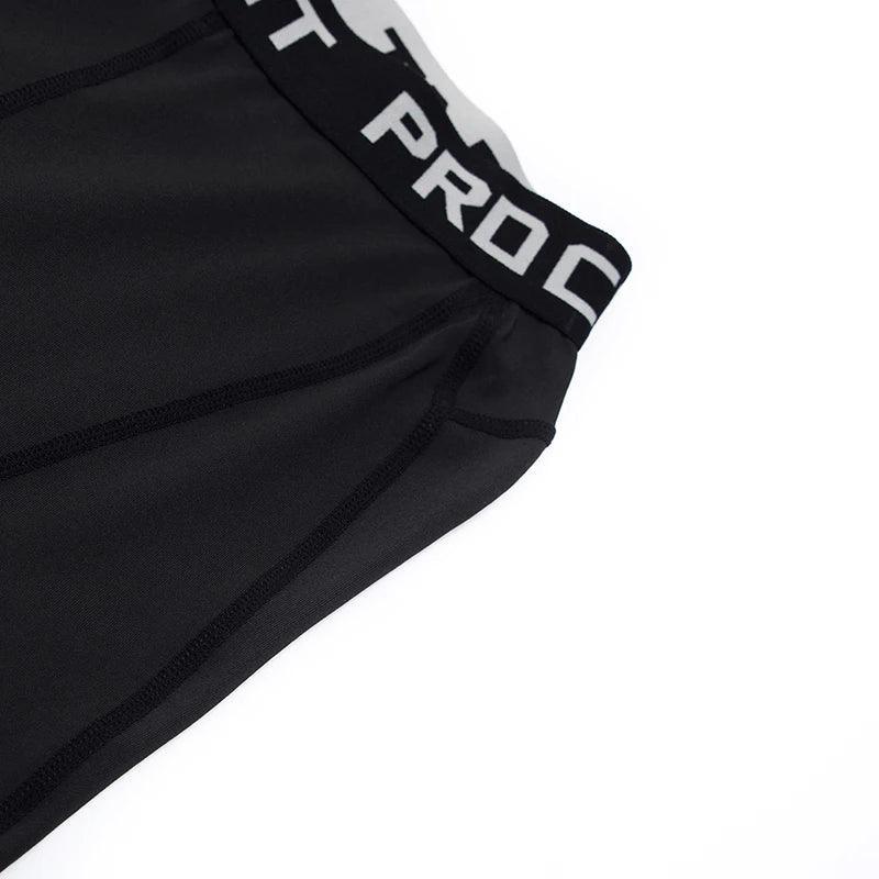 Black athletic shorts with white branding on a white background