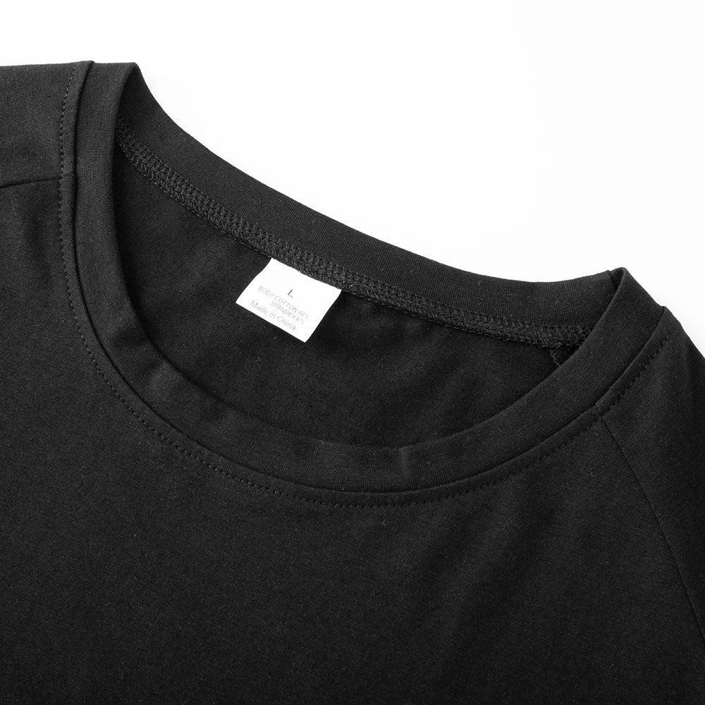 Close-up of a black t-shirt collar with a visible brand label on a white background