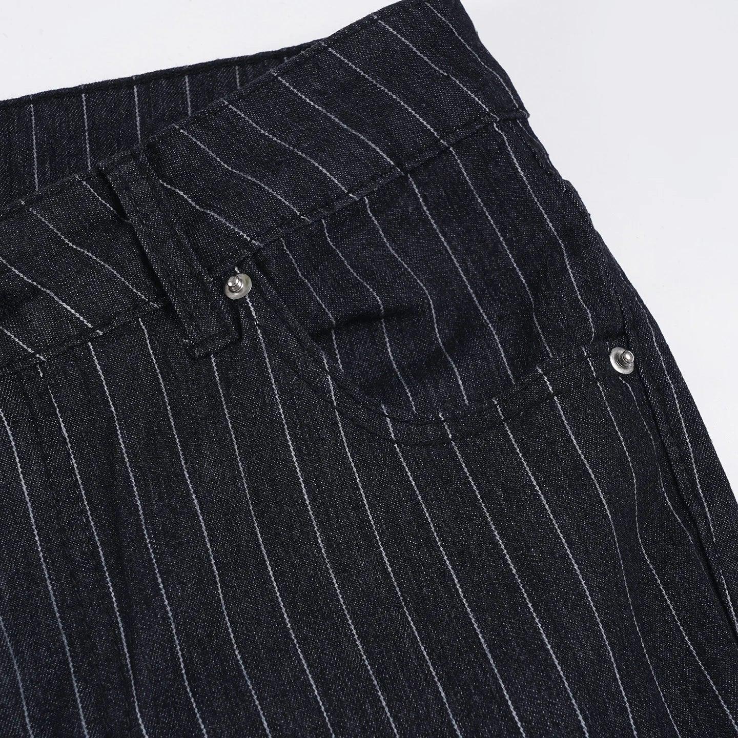 Close-up of black pinstripe pants with button details on a white background