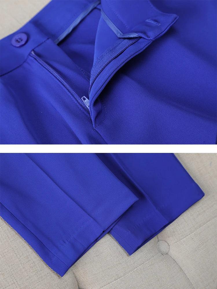 Close-up of a blue coat with a zipper on a beige surface