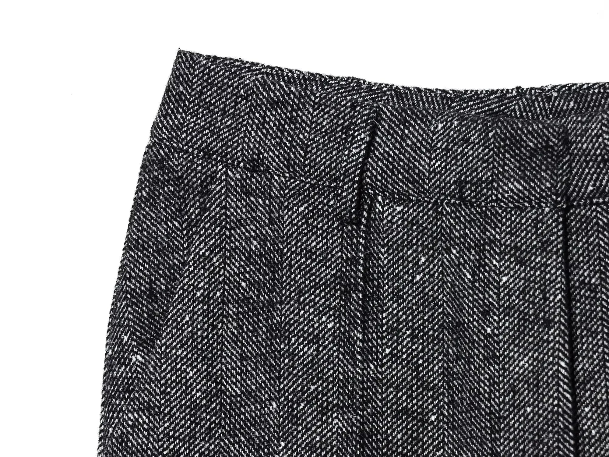 Close-up of a textured black and gray fabric with a herringbone pattern.