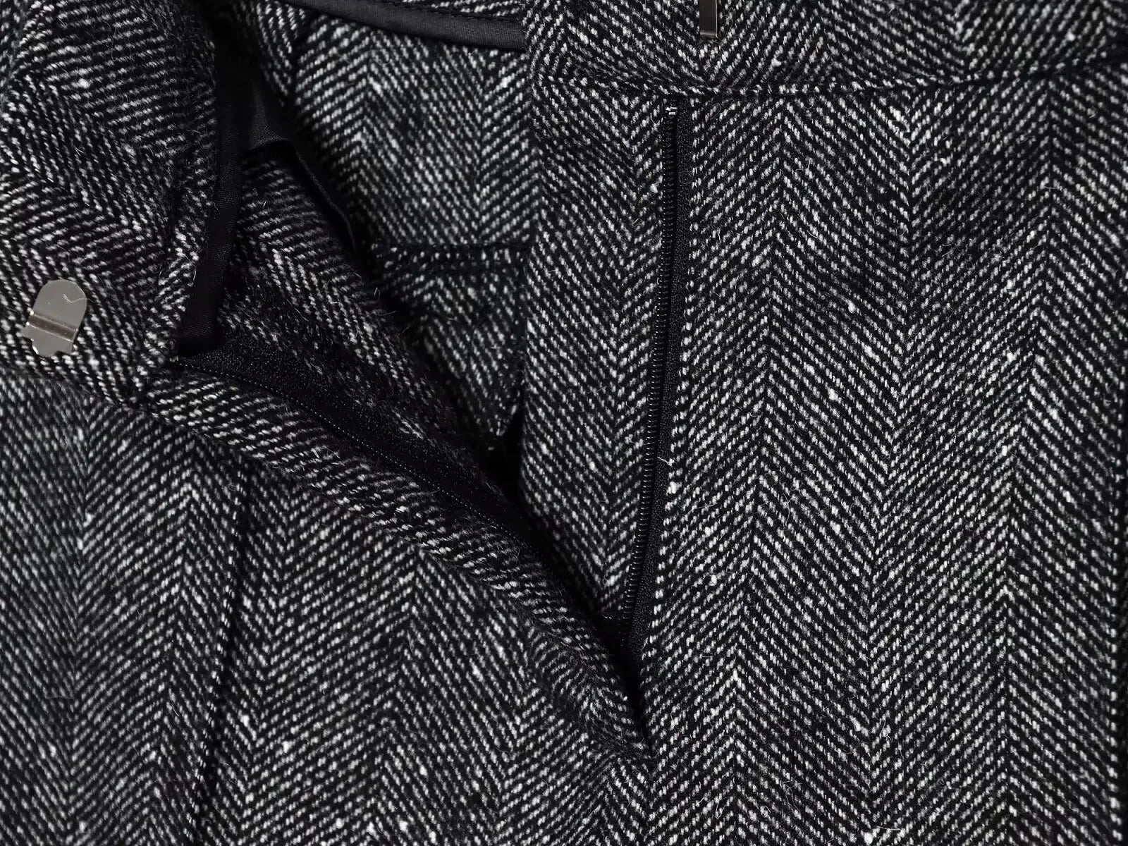 Close-up of a textured fabric with a herringbone pattern