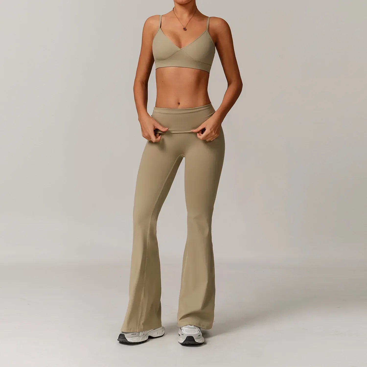 Two-piece cream colored activewear set featuring a supportive push up sports bra and high-waisted wide leg yoga pants - BetterPlace