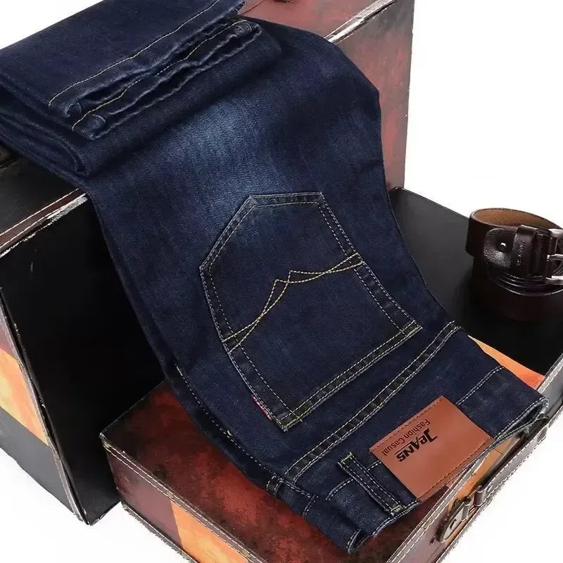 Folded blue jeans with a brand label on a wooden surface